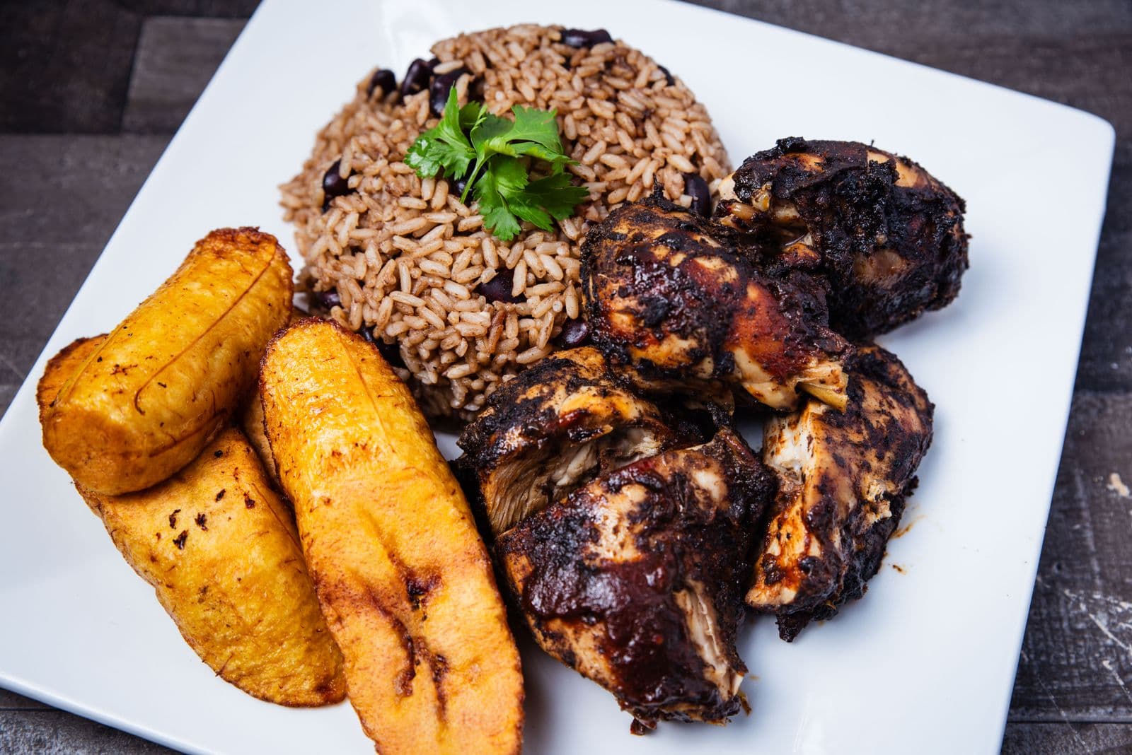 Jerk chicken platter with rice and peas and fried plantains