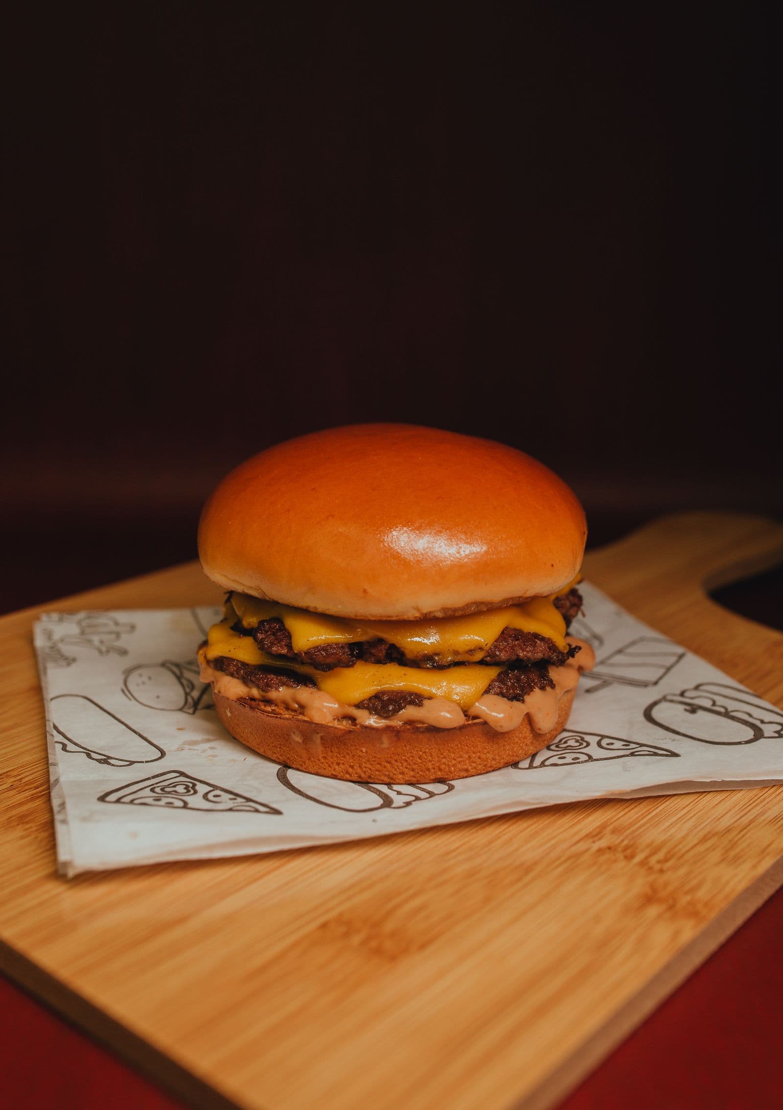 Double smashburger with draped cheese on wrap paper